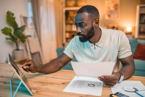 Person reviewing finances on laptop with charts and graphs, representing financial success and money management