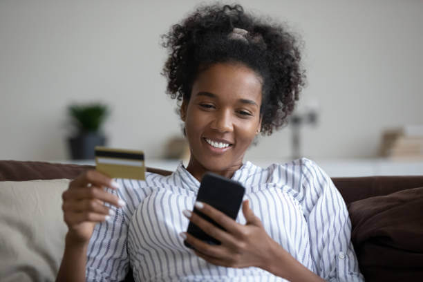 Happy lady using a CBN-approved loan app on smartphone in Nigeria, 2025
