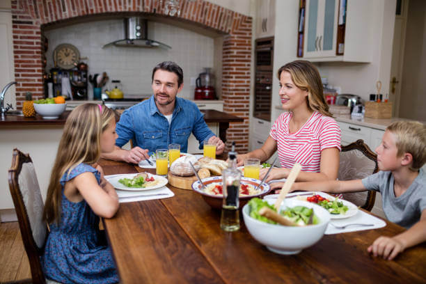 Family dining together at home to save money instead of eating out.